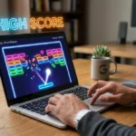 A player smashing colorful blocks on a laptop screen to achieve a Google Block Breaker high score.
