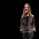 Amy Sherrill speaking at a public event as people search for her background and biography