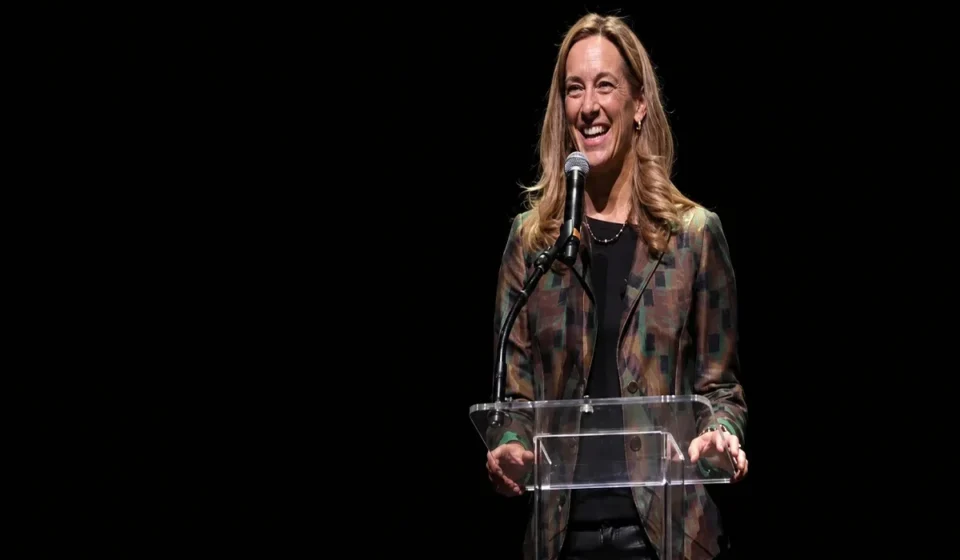 Amy Sherrill speaking at a public event as people search for her background and biography