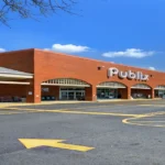 A Publix grocery store with a closing notice highlighting store closures in 2026.